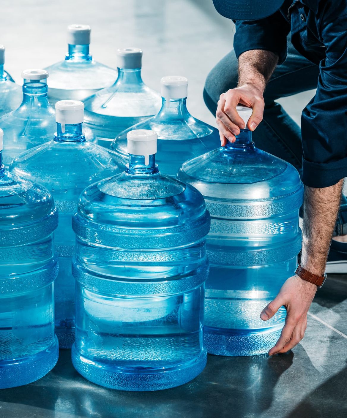 man loading water bottles